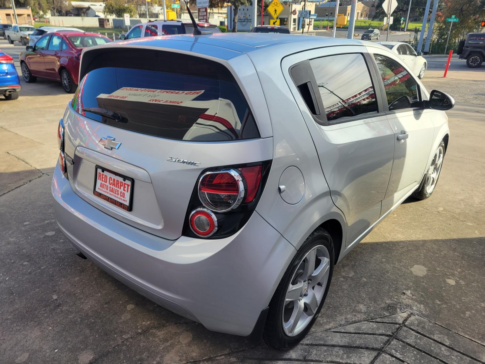 2014 SILVER Chevrolet Sonic (1G1JB6SH6E4) with an 1.8L I4 F DOHC 16V engine, Manual Transmission transmission, located at 503 West Court, Seguin, TX, 78155, (830) 379-3373, 29.568621, -97.969803 - 2014 Chevrolet Sonic LS Manual 5-Door with a 1.8L I4 F DOHC 16V, Standard Transmission, Tilt, AM/FM/AUX Stereo, Power Locks, Bluetooth, Tinted Windows, Onstar Capability, Alloy Wheels, Rear Wiper, Rear Defroster - Photo #2